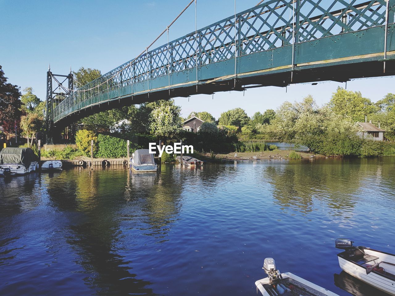 VIEW OF SUSPENSION BRIDGE OVER RIVER