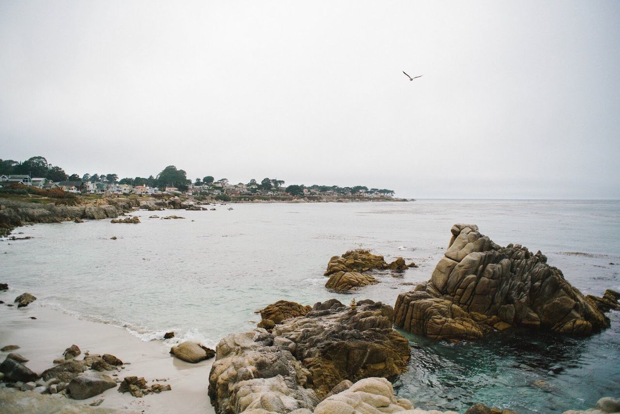 ROCKS IN SEA AGAINST SKY