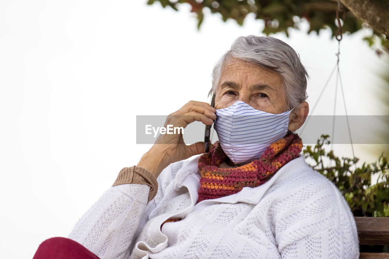 Portrait of woman with snow covered sitting outdoors