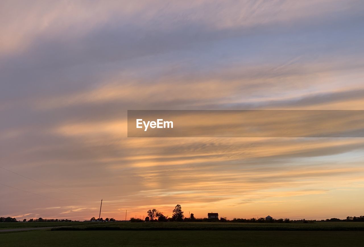 Scenic view of field against sky during sunset