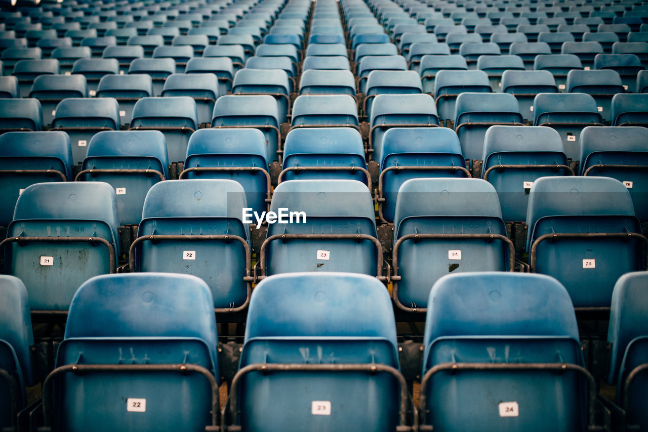 Full frame shot of empty blue seats in stadium