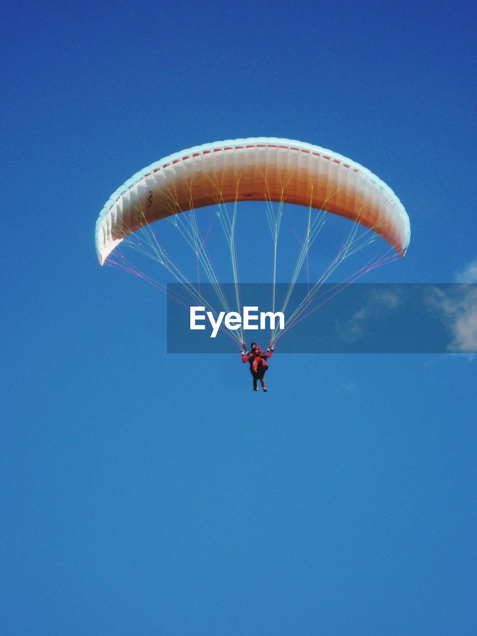 LOW ANGLE VIEW OF PERSON PARAGLIDING AGAINST CLEAR SKY