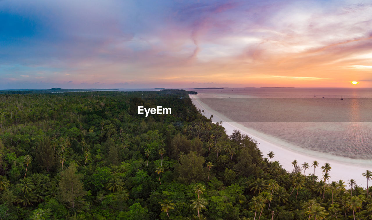 SCENIC VIEW OF BEACH AGAINST SKY DURING SUNSET