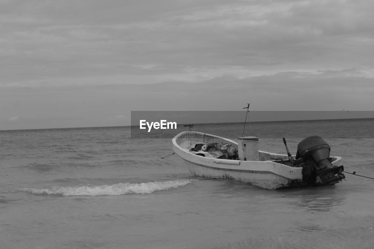 BOAT ON SEA AGAINST SKY