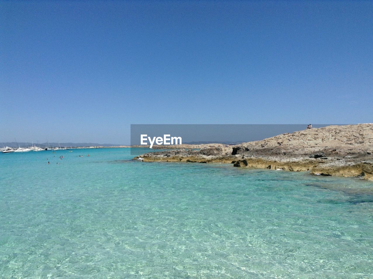 Scenic view of sea against clear blue sky