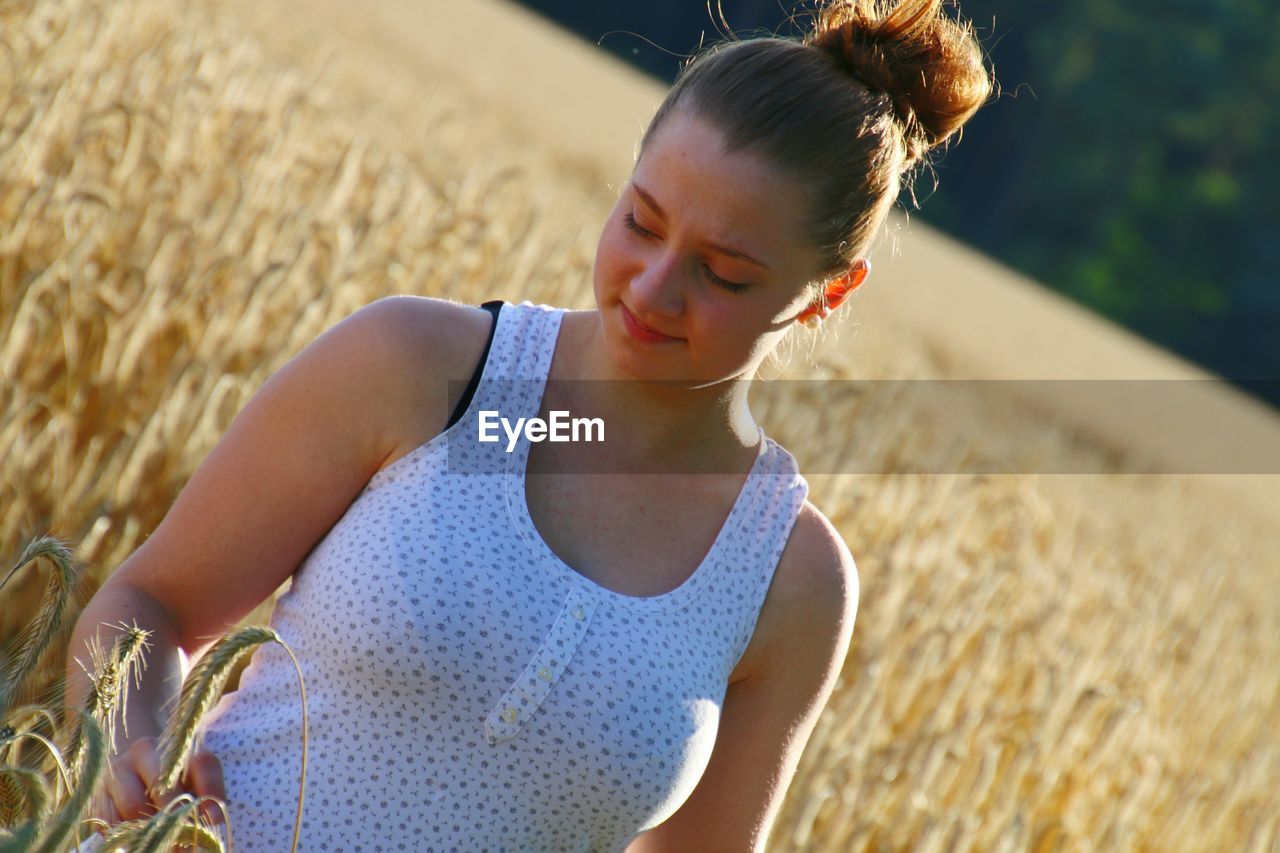 Tilt image of woman standing in farm during sunny day