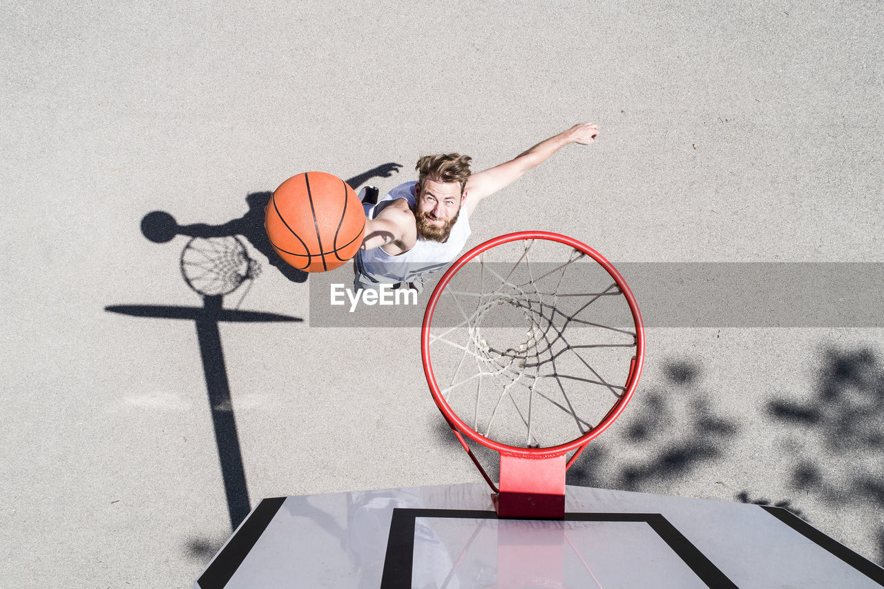 Man playing basketball on outdoor court