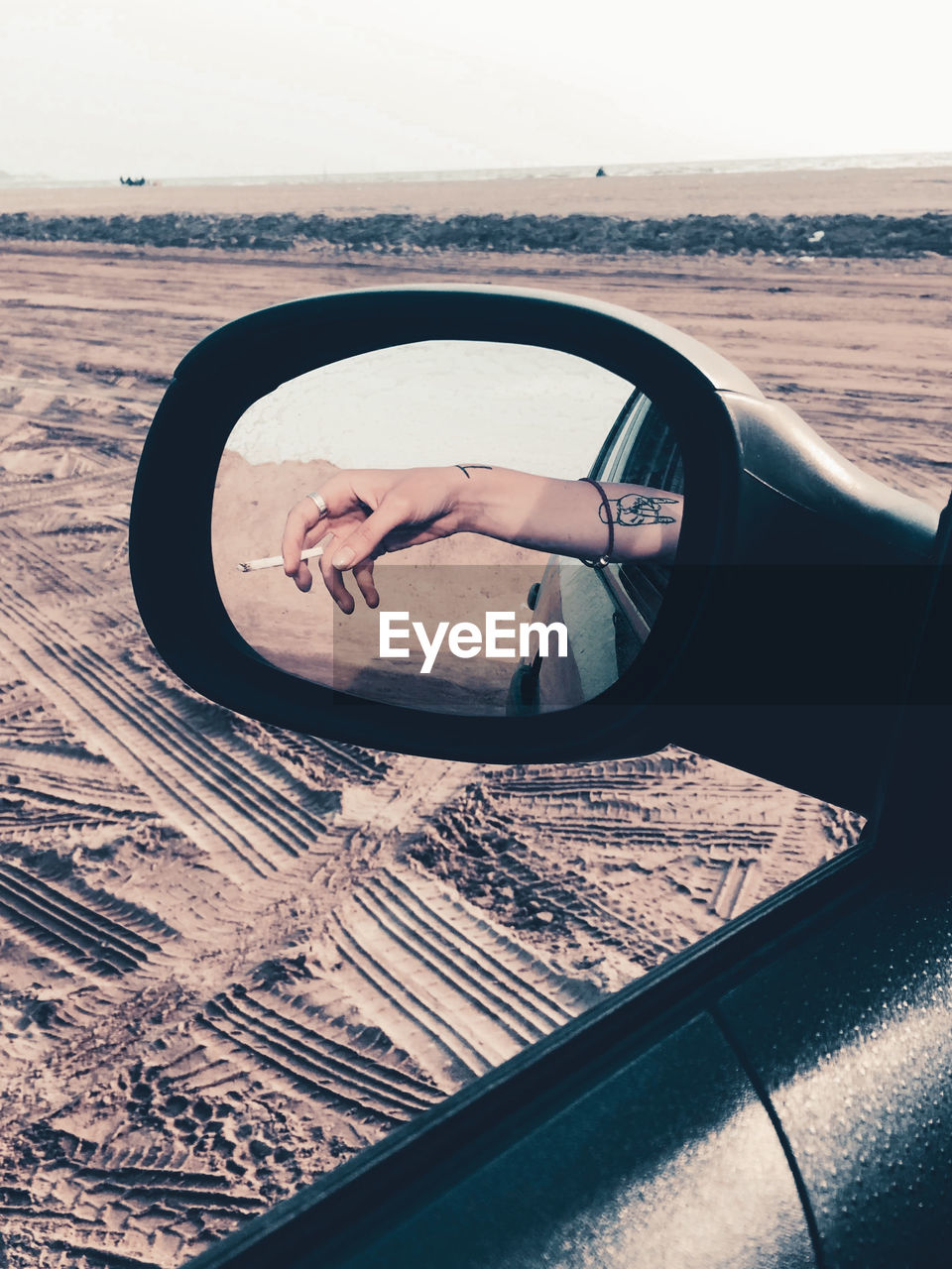 REFLECTION OF MAN PHOTOGRAPHING MIRROR ON CAR