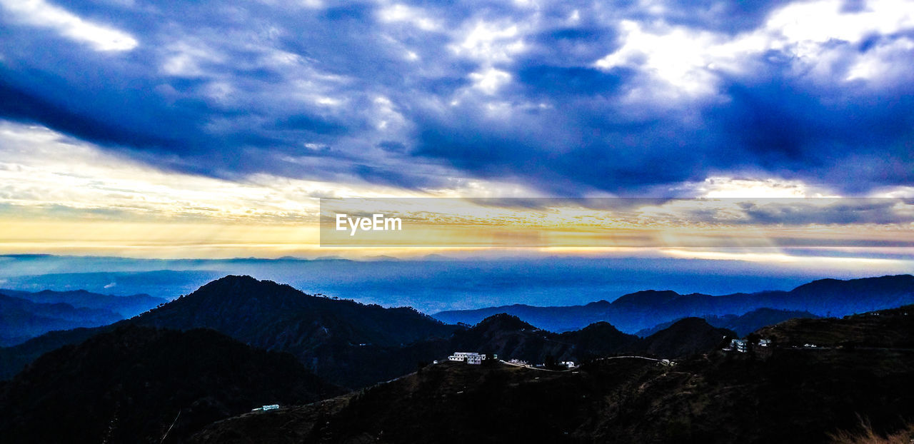 SCENIC VIEW OF DRAMATIC SKY OVER SILHOUETTE MOUNTAINS