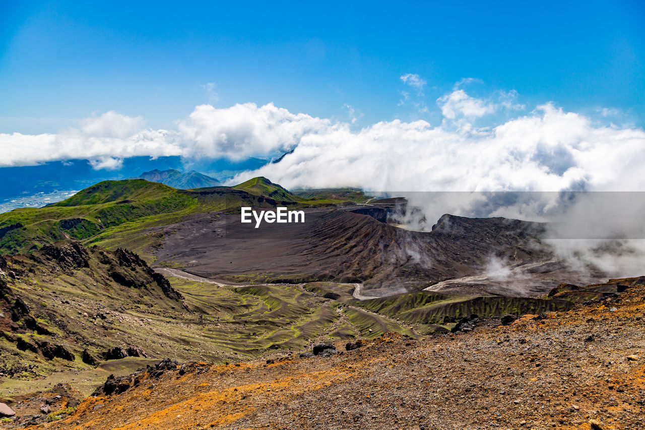 Scenic view on volcanic landscape, aso crater with clouds, aso town in kyushu, japan