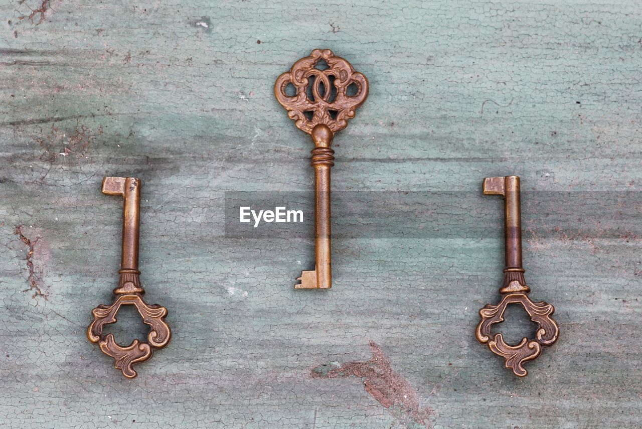 Directly above shot of vintage keys on wooden table