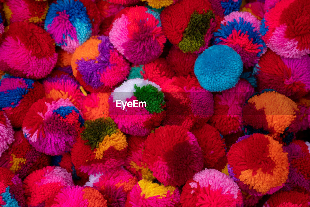 Full frame shot of multi colored pom poms