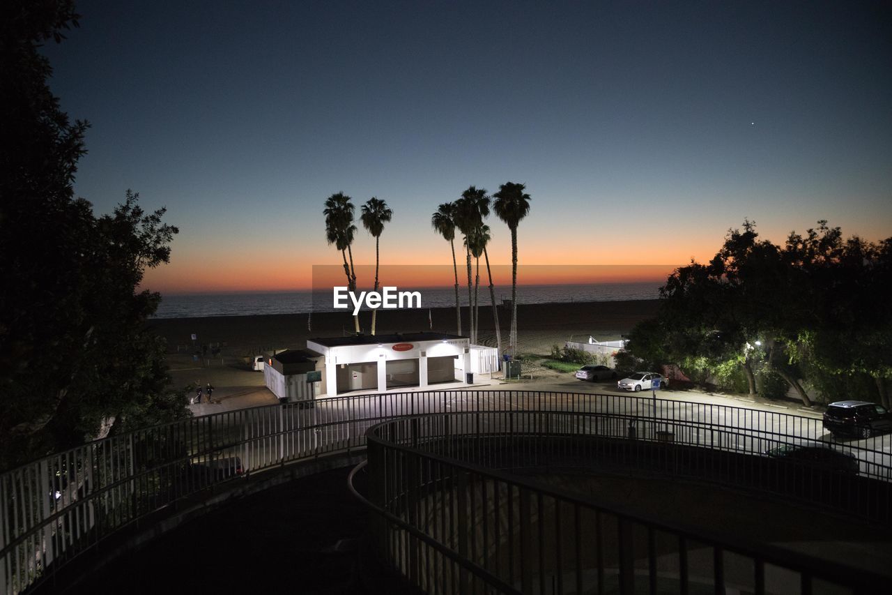 VIEW OF BRIDGE OVER SEA AGAINST SKY DURING SUNSET