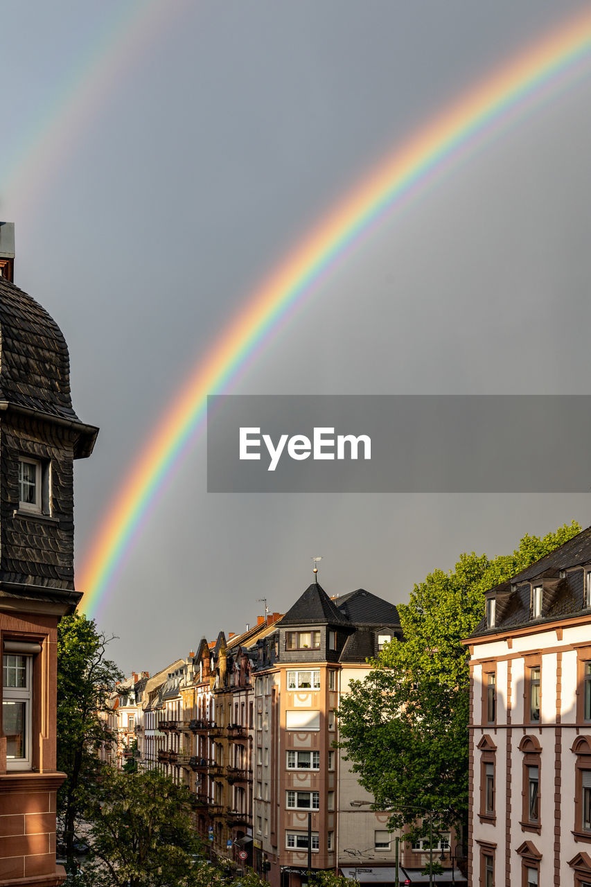 Rainbow over buildings in city