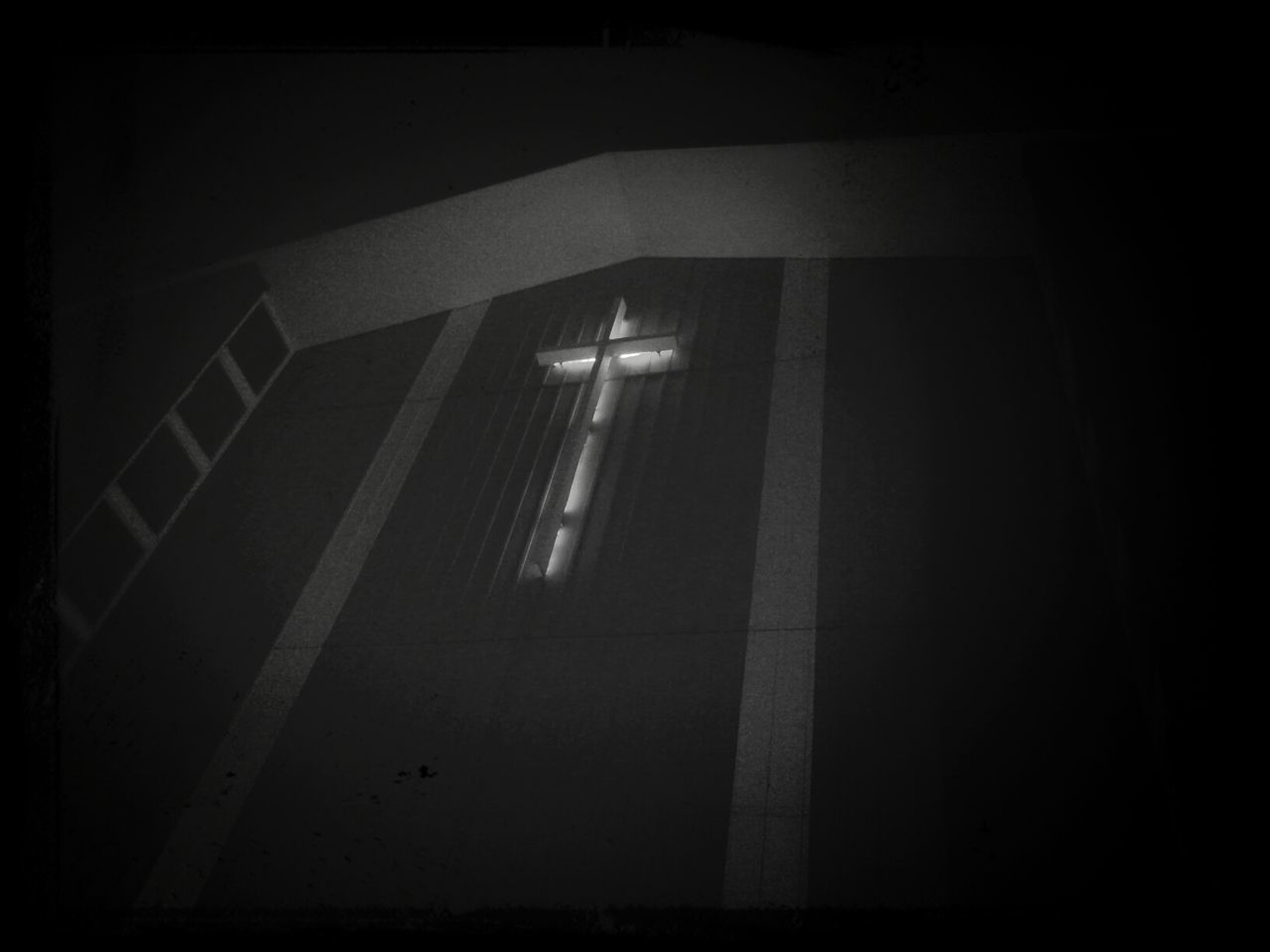 Low angle view of cross on wall