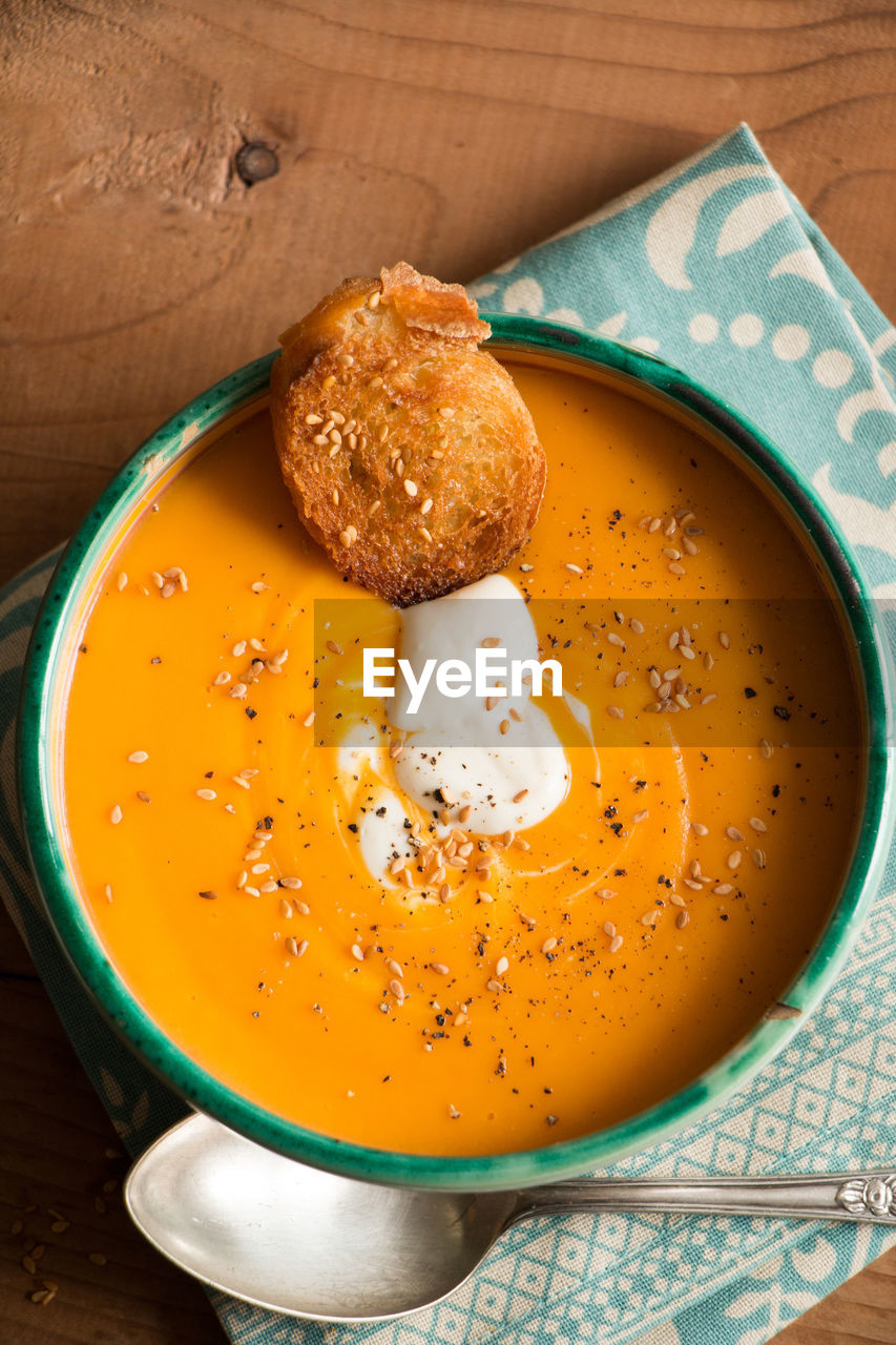 High angle view of pumpkin soup in bowl on table