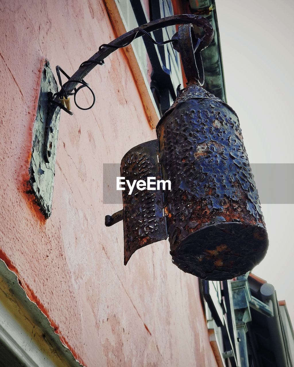 Low angle view of lighting equipment hanging outside building