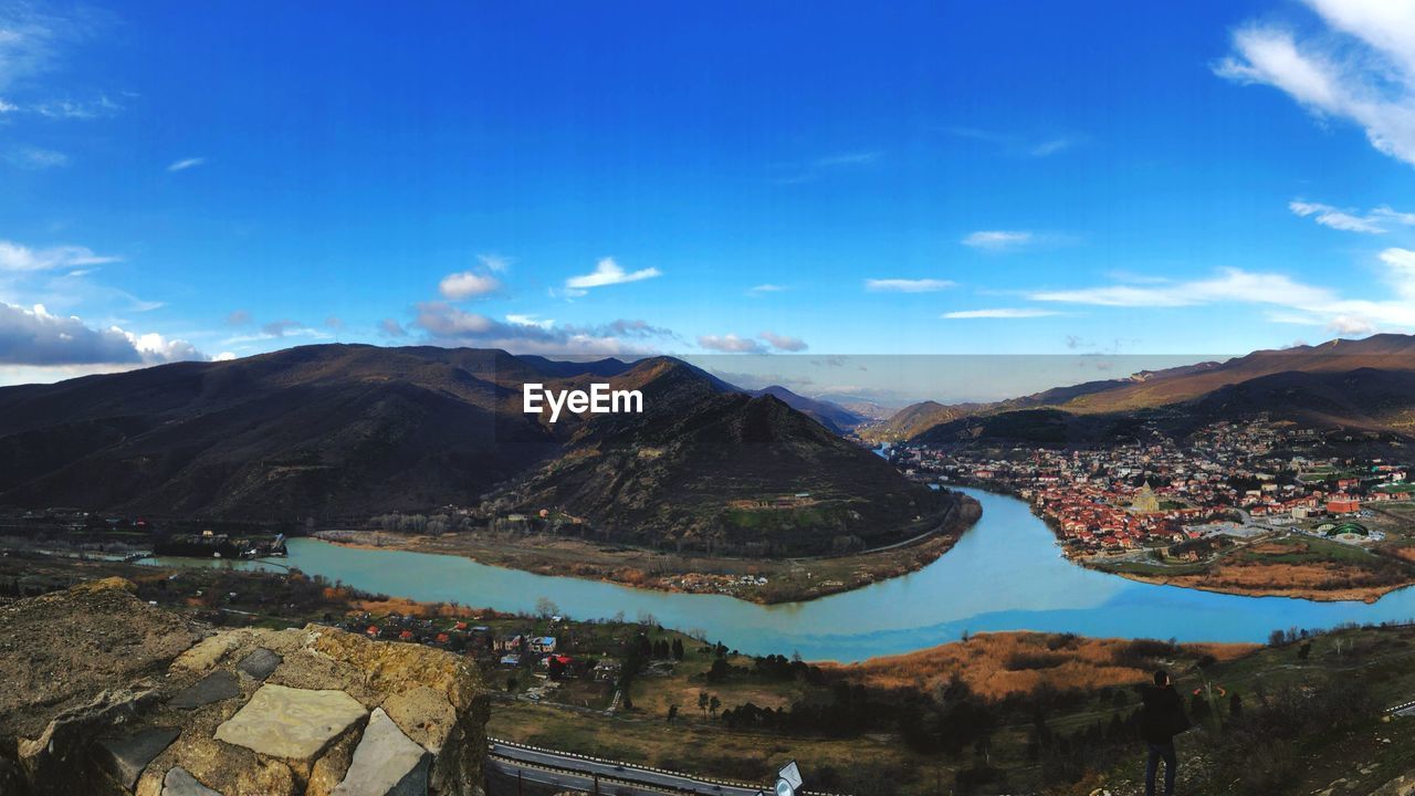 Panoramic view of mountains against blue sky