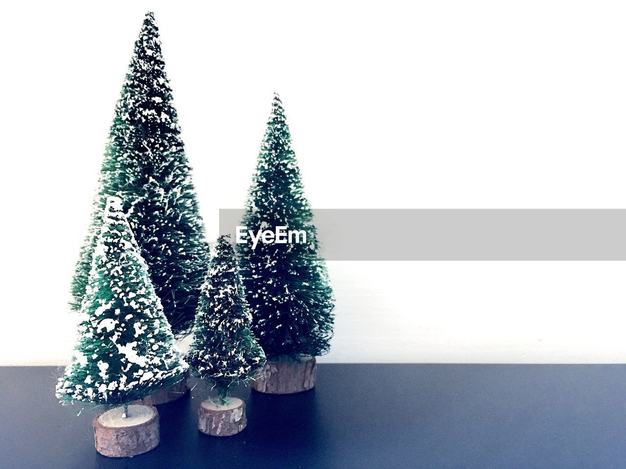 Christmas trees on table against white background