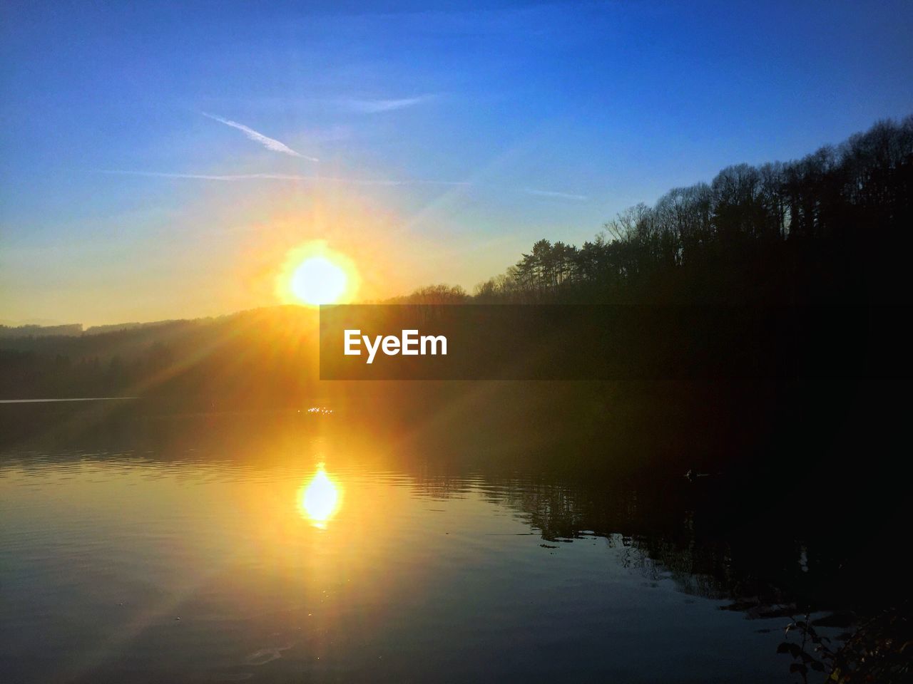 SCENIC VIEW OF SUNSET OVER LAKE