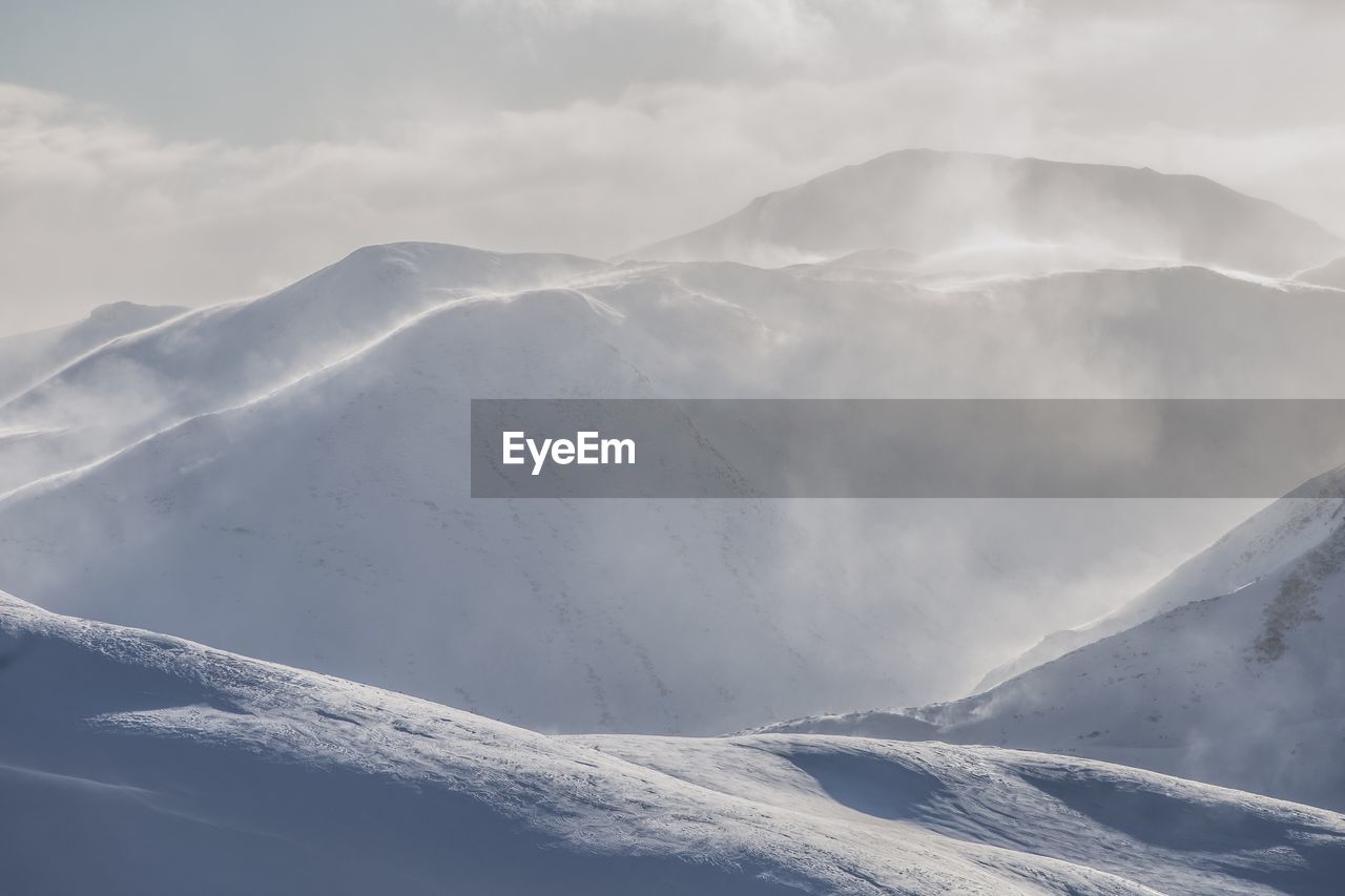 Scenic view of snow covered mountains against sky