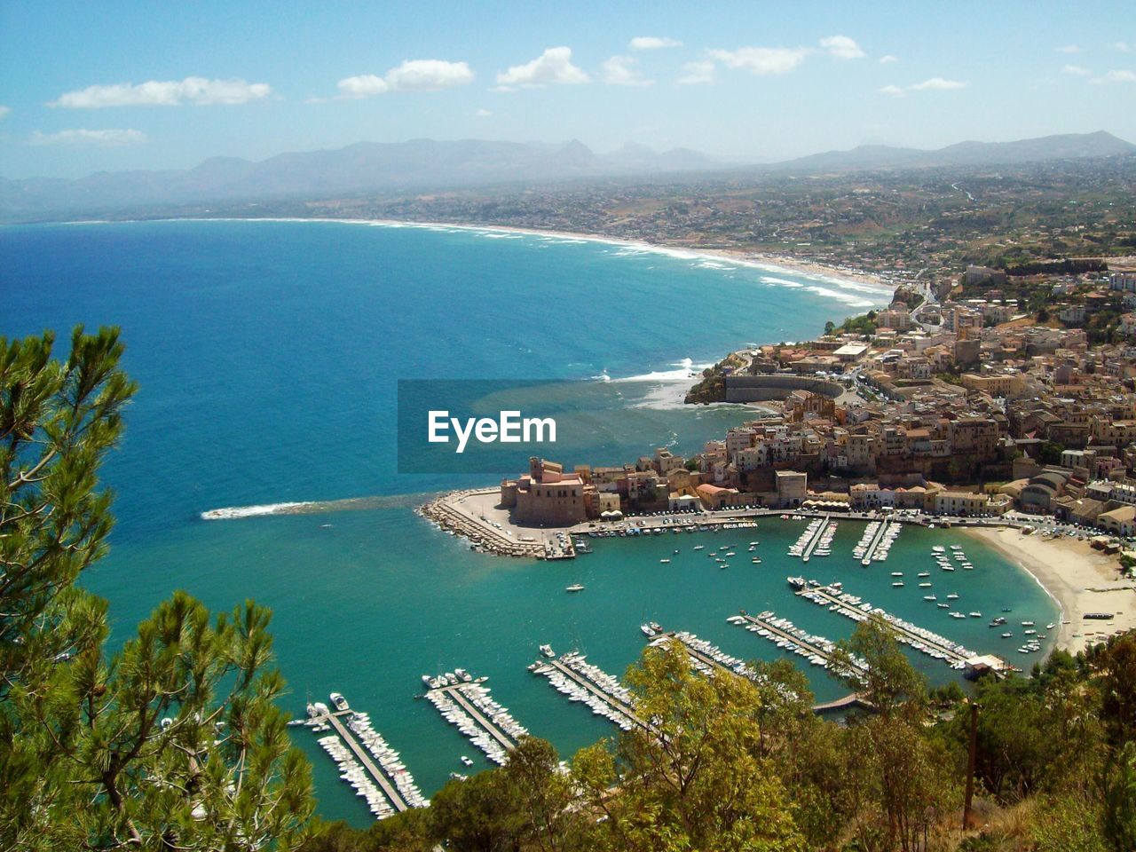 High angle view of sea and cityscape against sky