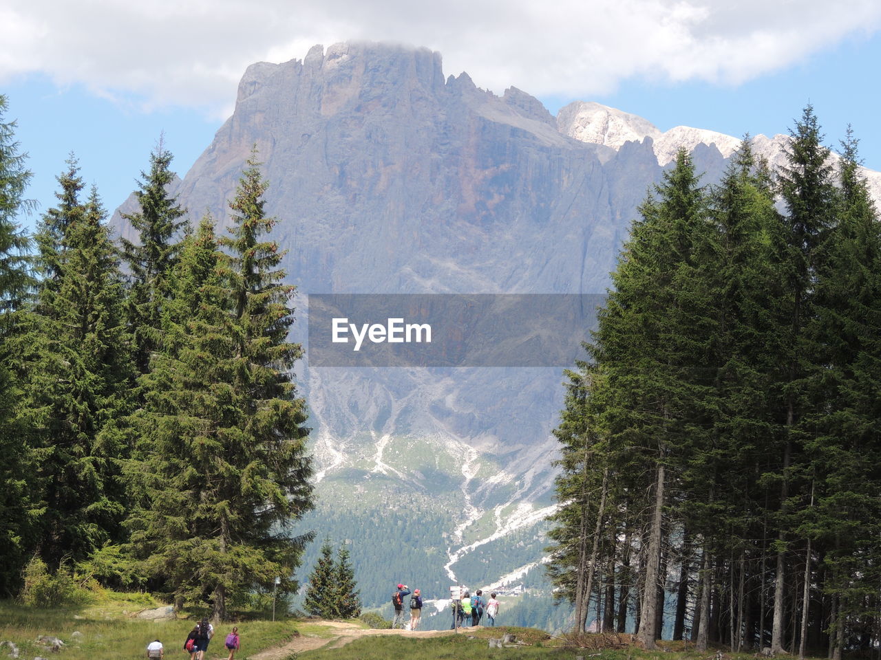 People on mountain against sky