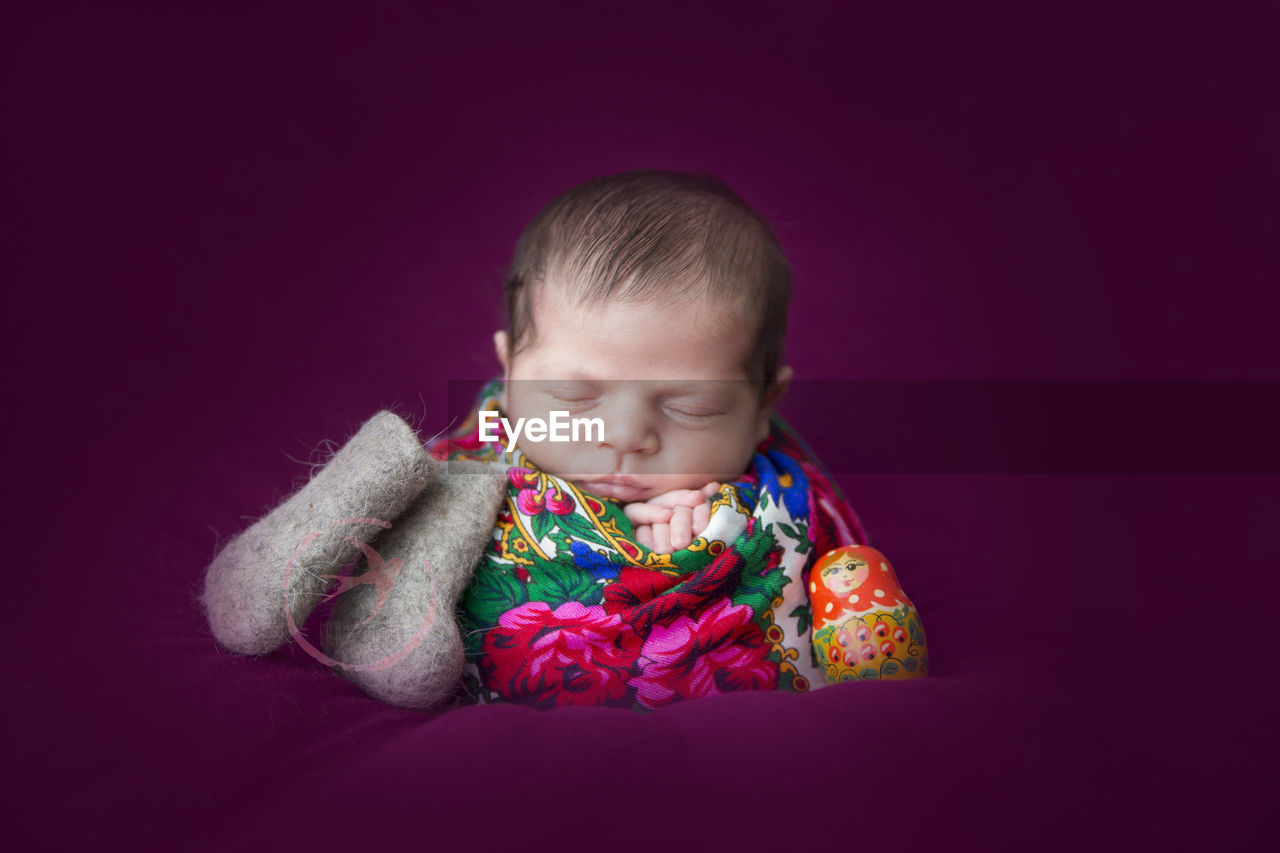 PORTRAIT OF CUTE BABY BOY AGAINST COLORED BACKGROUND