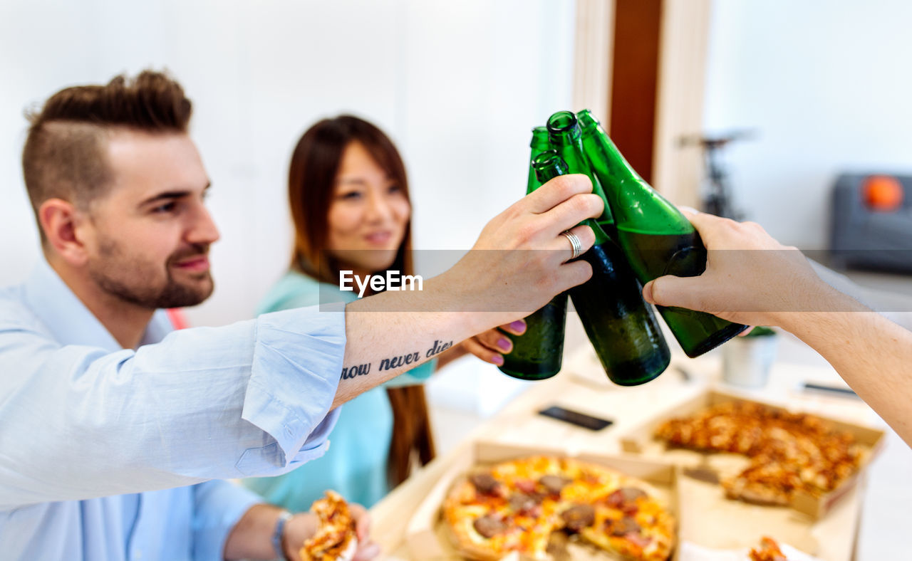 Friends toasting drink bottles