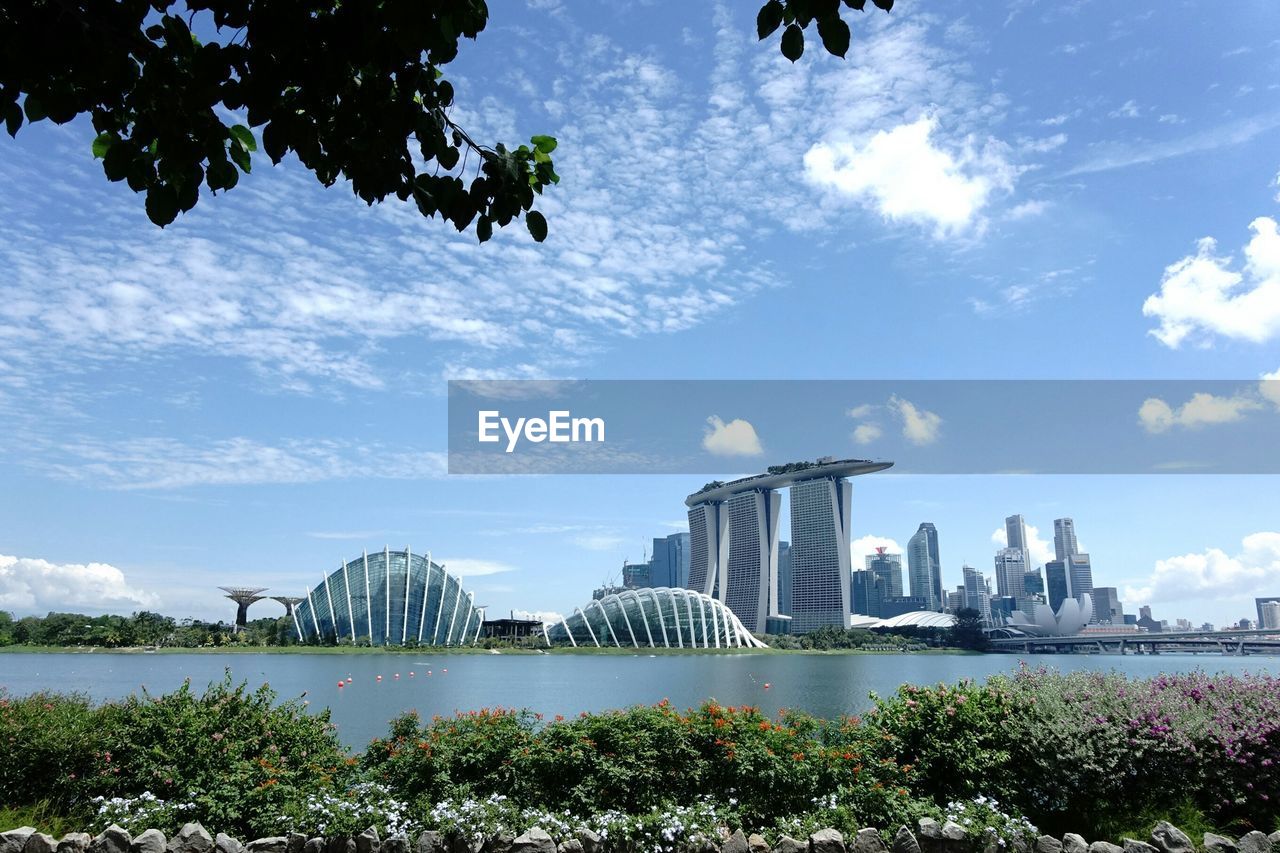 Buildings against cloudy sky