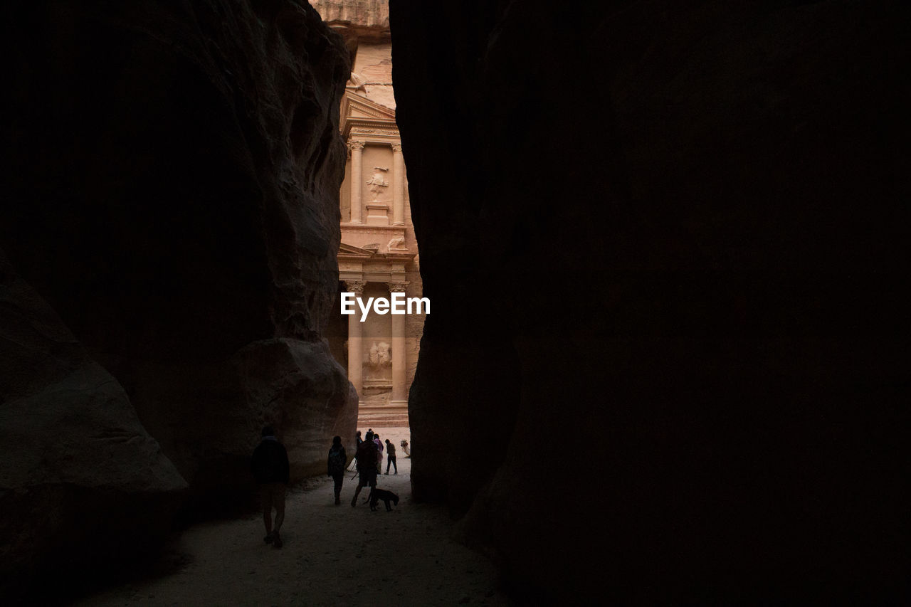 The two horizontal walls of the canyon give a glimpse of al-khazneh in petra early morning.