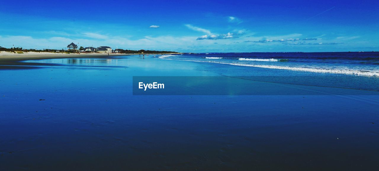 Scenic view of sea against blue sky