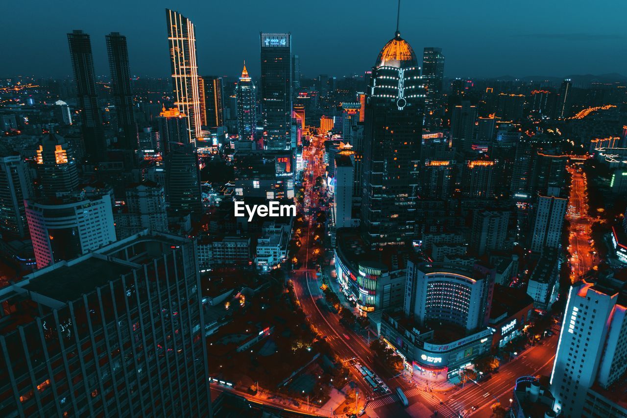 High angle view of illuminated buildings against sky at night