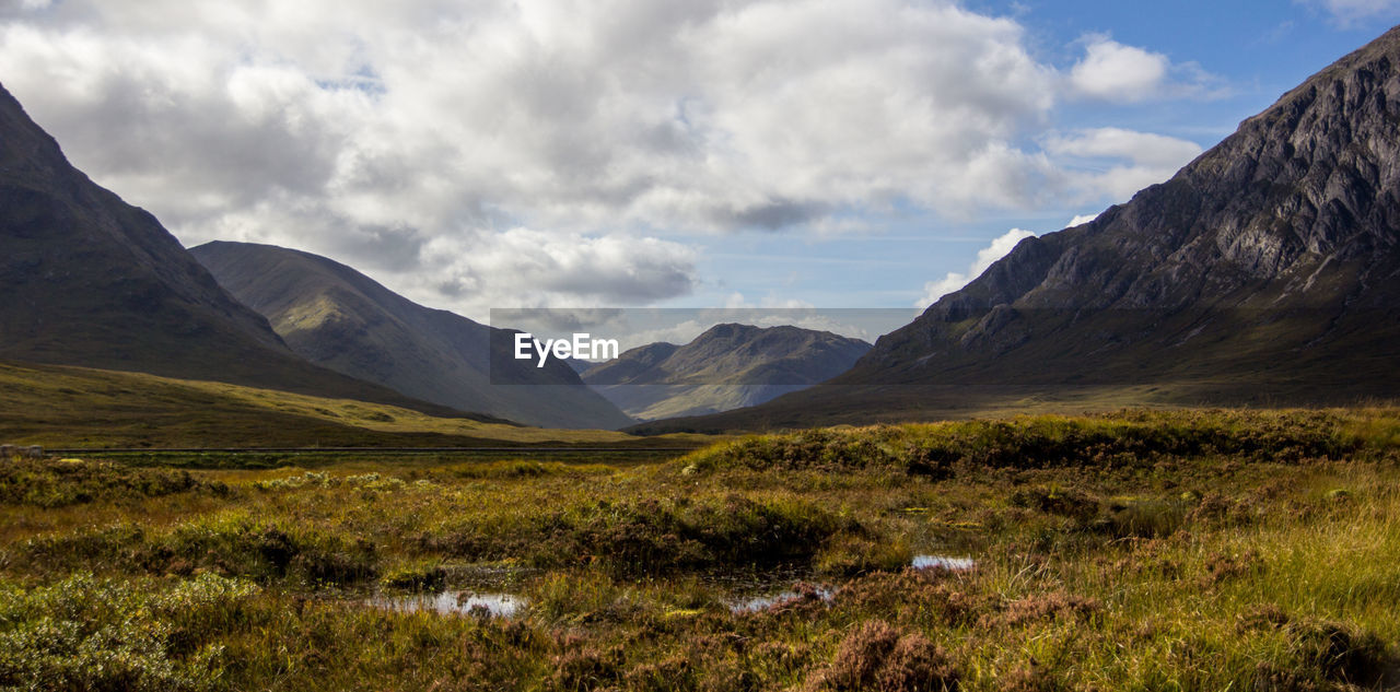 View of mountain range against cloudy sky