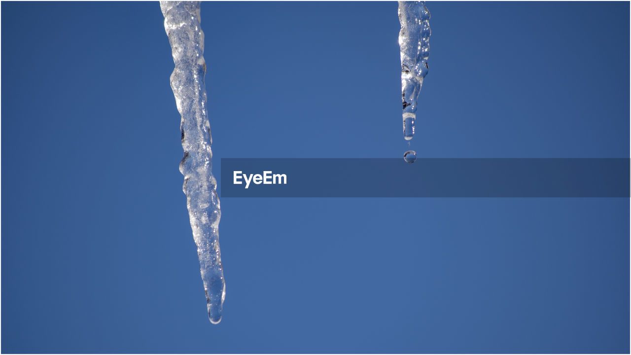 CLOSE-UP OF ICE CRYSTALS AGAINST CLEAR SKY