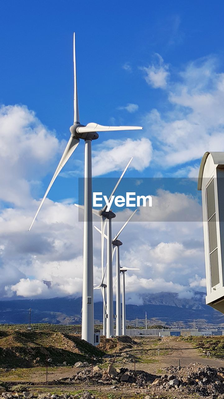 Windmill on field against sky