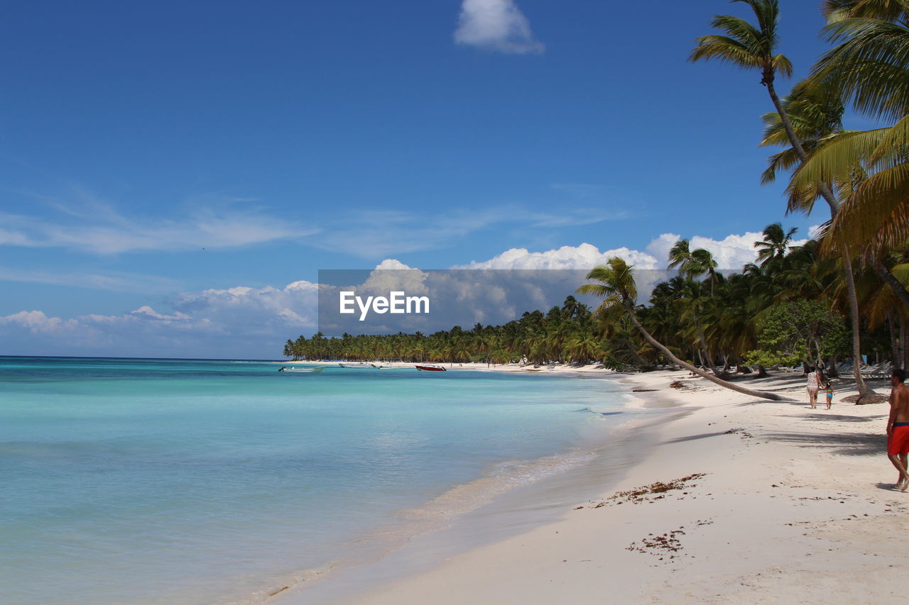 Scenic view of beach against cloudy sky