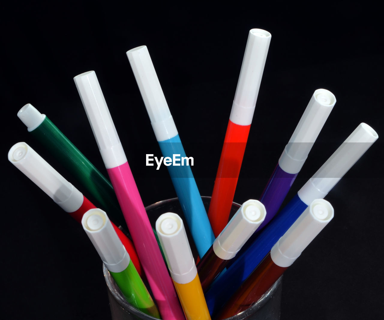 High angle view of felt tip pens against black background