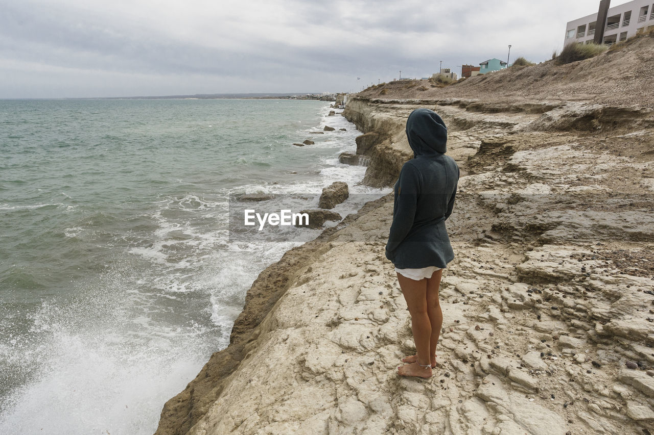 Side view of woman standing on beach