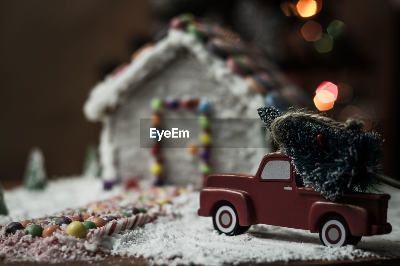 CLOSE-UP OF TOY CAR ON CHRISTMAS TREE