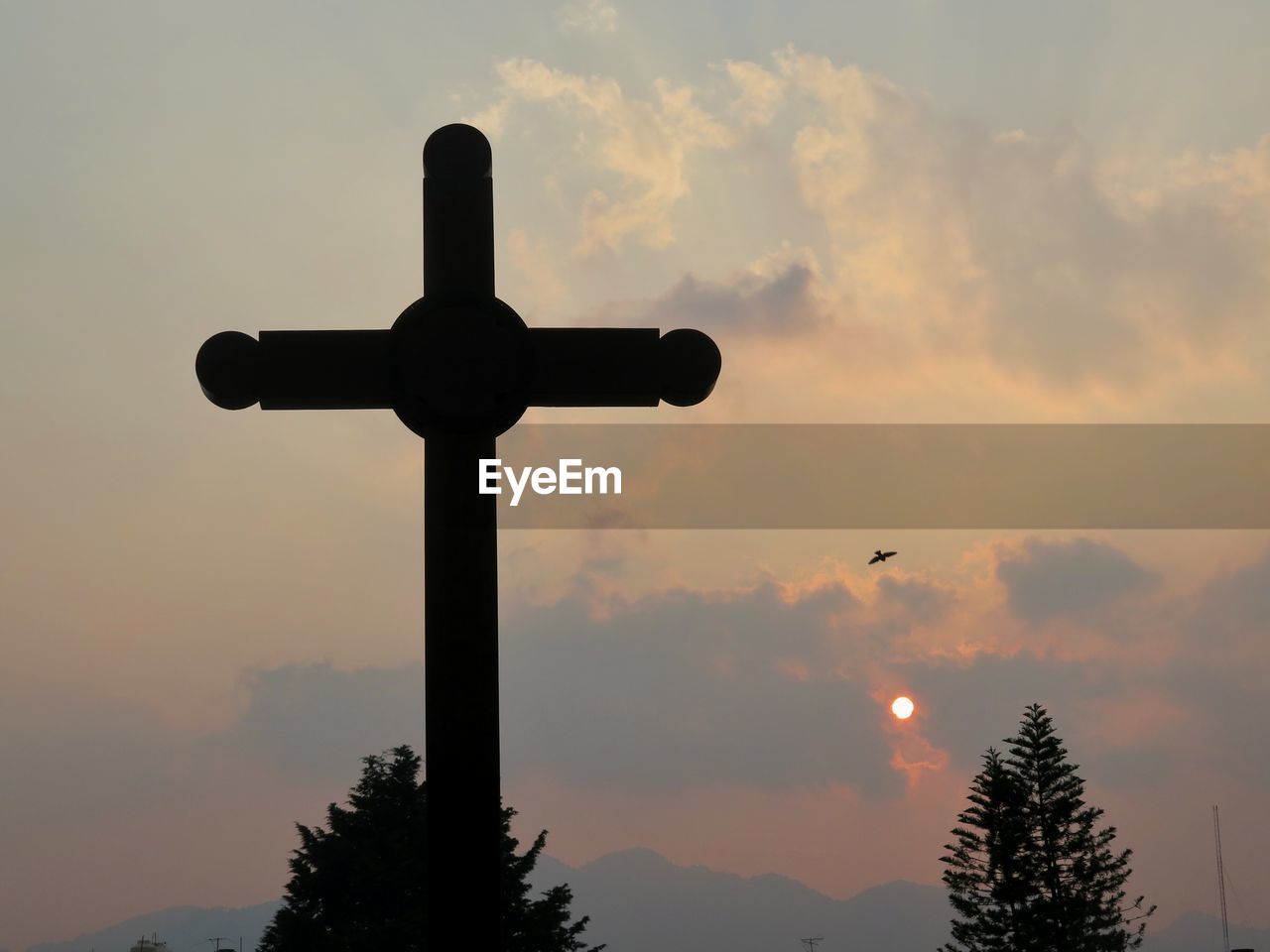 Low angle view of cross against sky during sunset