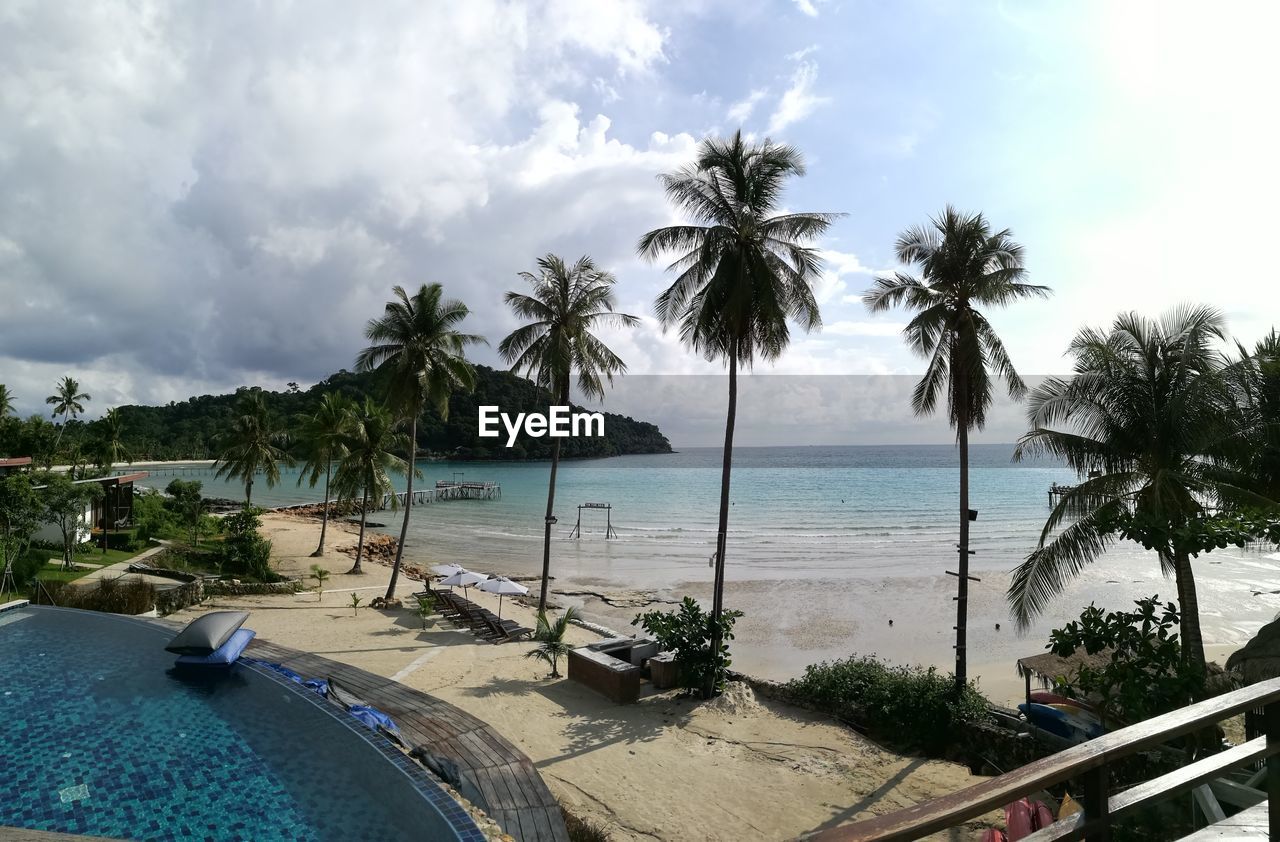 SCENIC VIEW OF SWIMMING POOL BY SEA AGAINST SKY