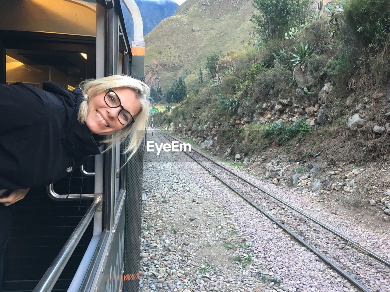 Portrait of smiling woman in train