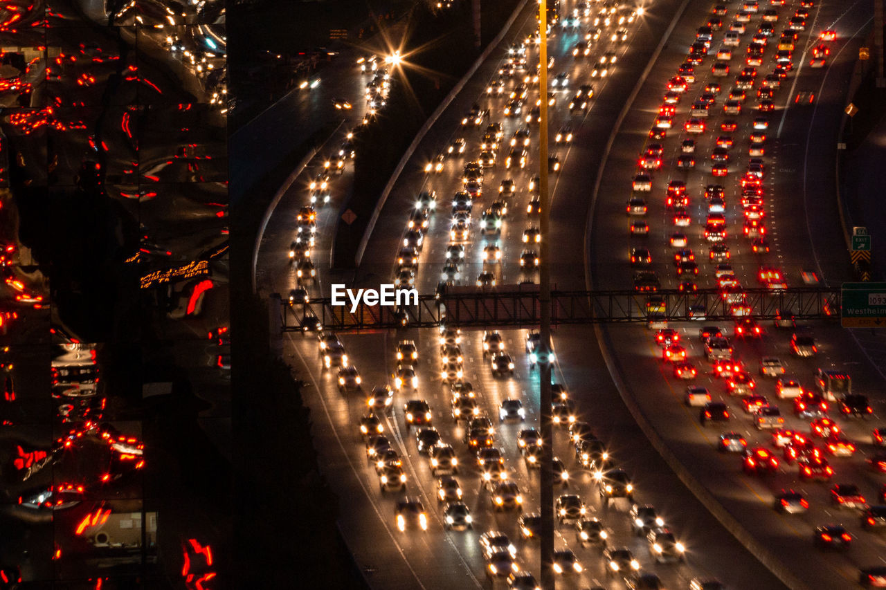 High angle view of illuminated vehicles on road at night