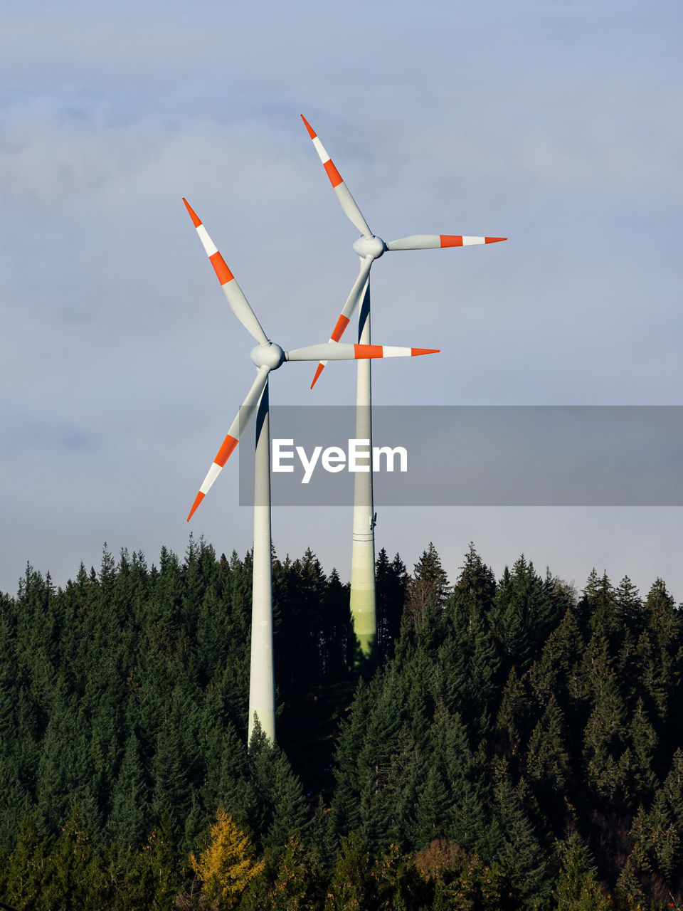Windmills / wind turbines on a hilltop above the clouds in the black forest, germany