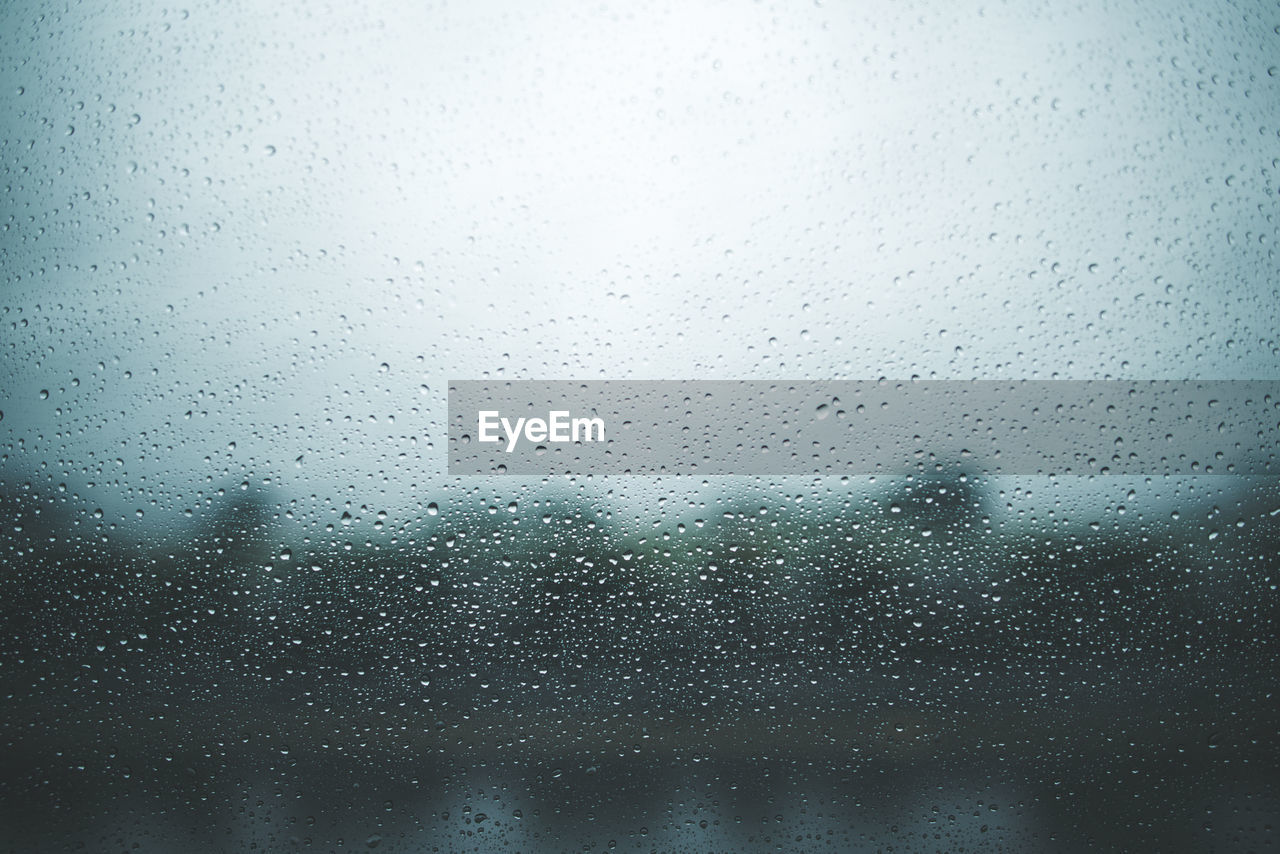 Full frame shot of wet glass window during rainy season