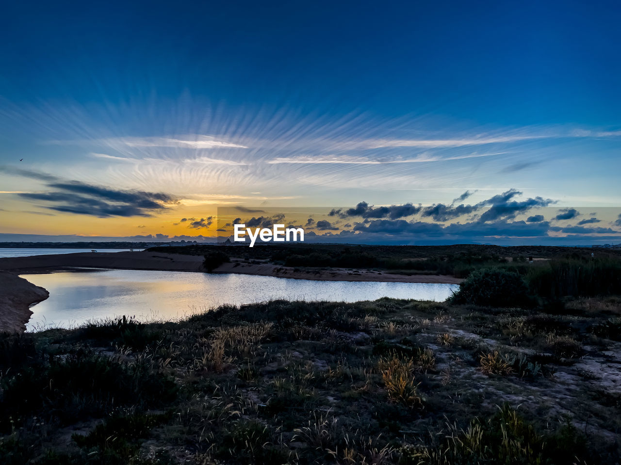 sky, water, reflection, horizon, dawn, scenics - nature, sunrise, cloud, morning, sea, beauty in nature, shore, nature, landscape, coast, environment, ocean, land, wave, no people, sunlight, tranquility, travel destinations, blue, travel, tranquil scene, mountain, snow, cold temperature, beach, body of water, outdoors, winter, plant, non-urban scene, bay, tourism