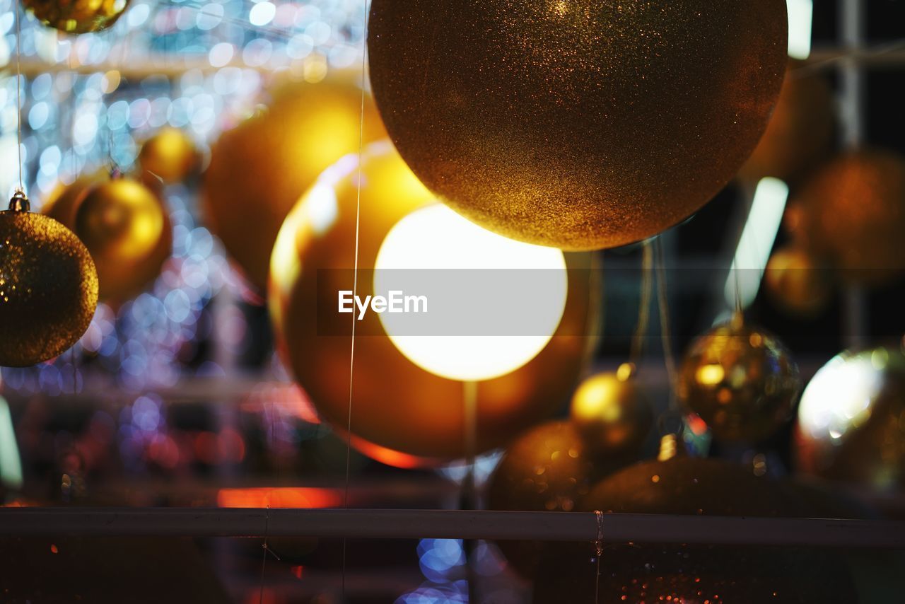 Close-up of baubles hanging at night