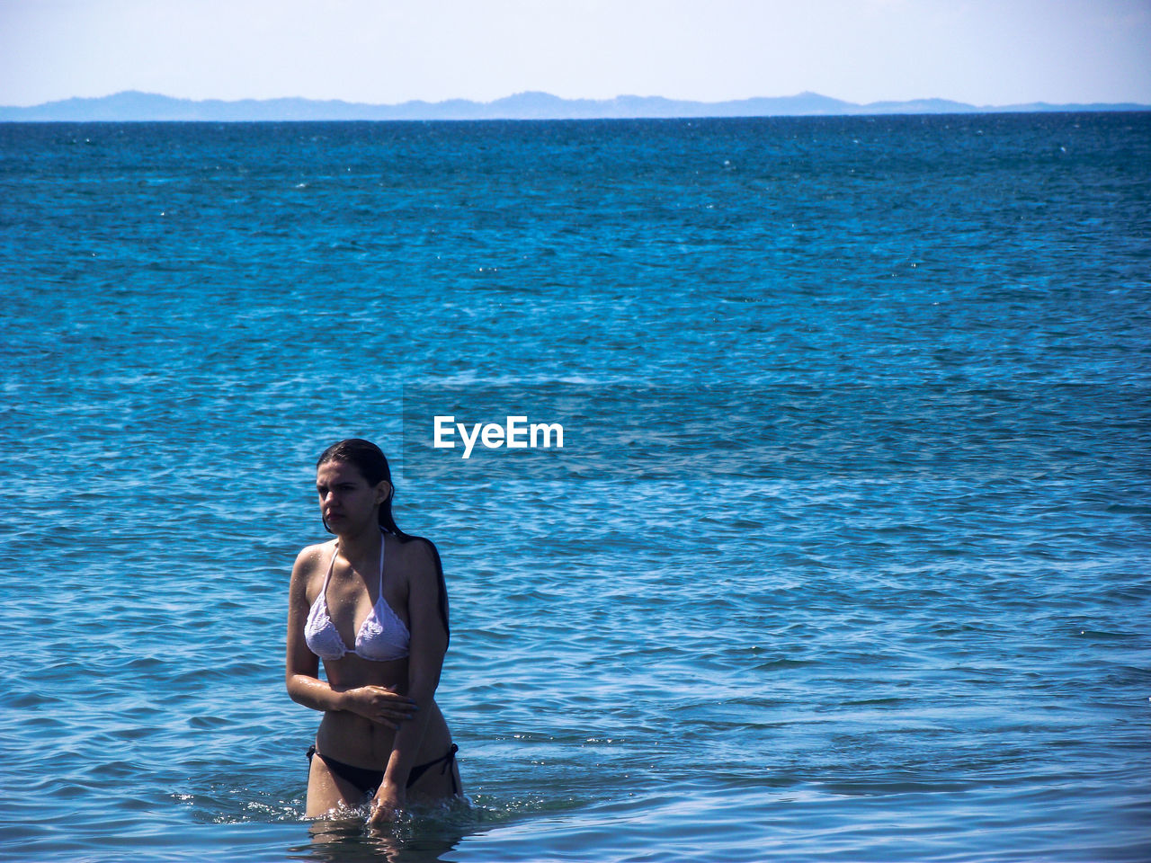 Sensuous woman wearing bikini while standing in sea