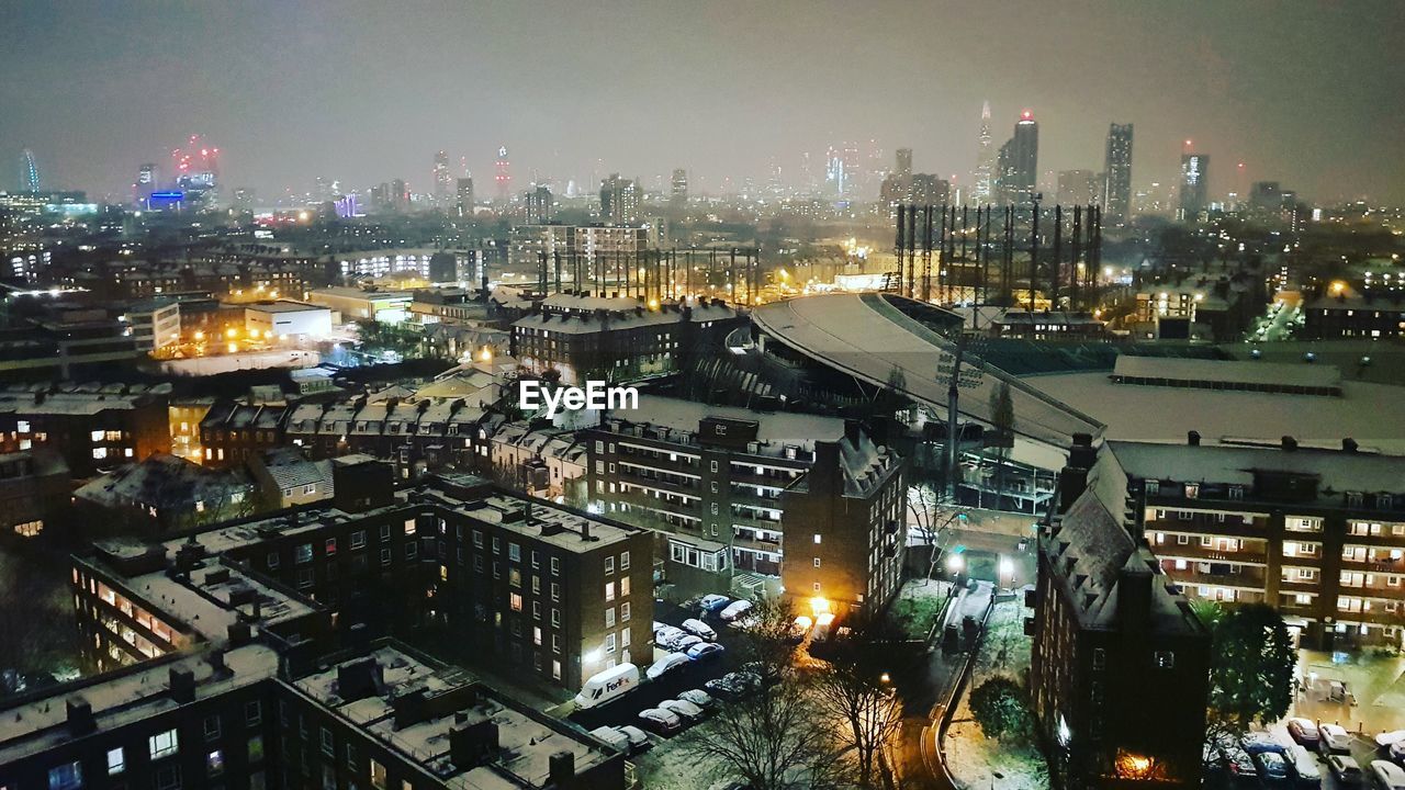 HIGH ANGLE VIEW OF ILLUMINATED CITY DURING WINTER